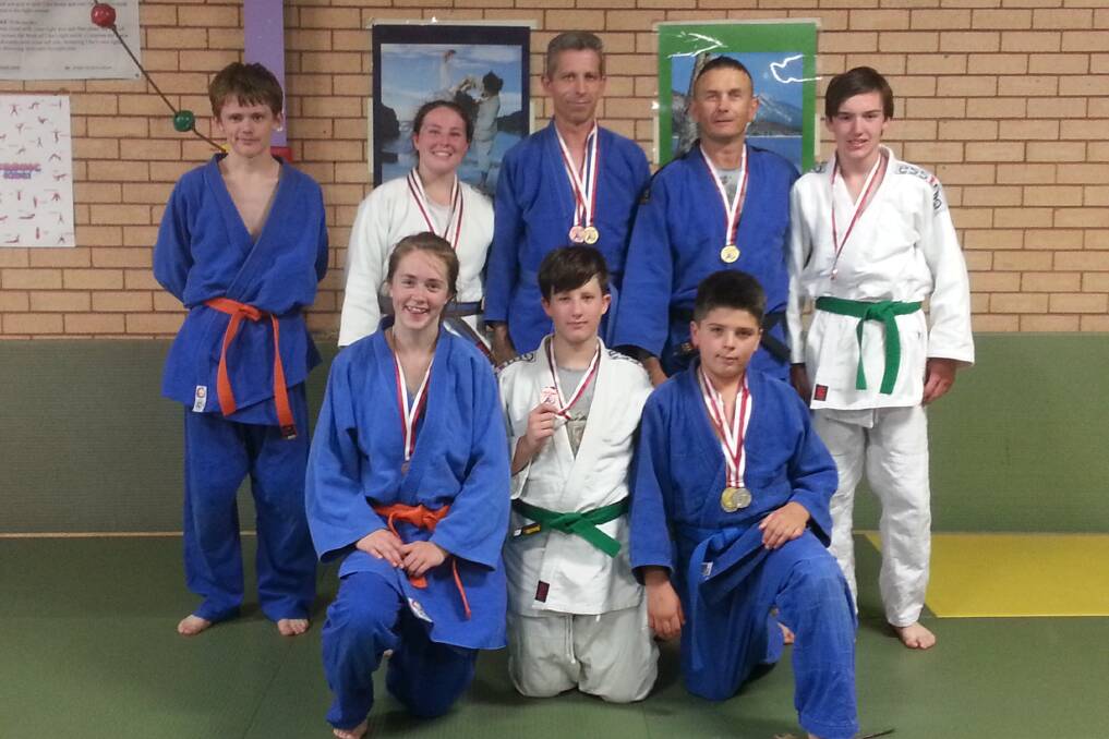 MEDAL HAUL: Wellington PCYC Judo competitors in Coffs Harbour. Pictured are (back) Dwayne Campbell, Caitlin Playford, Keith Playford, Tony Lindsay, Sean Behsman, (front) Ellie-Rose Campbell, Brodhain Edwards, Nat Lindsay. 


Photo: CONTRIBUTED.