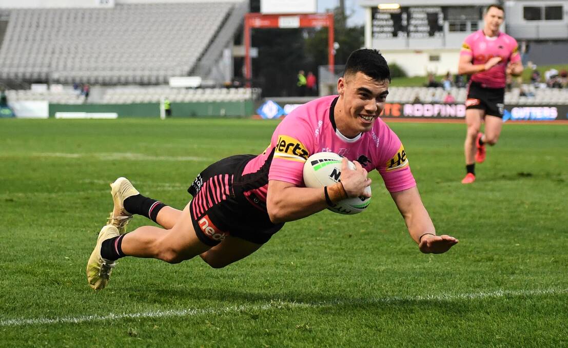 ALL SMILES: Charlie Staines flies in to score one of his four tries on debut on Saturday. Photo: NRL PHOTOS