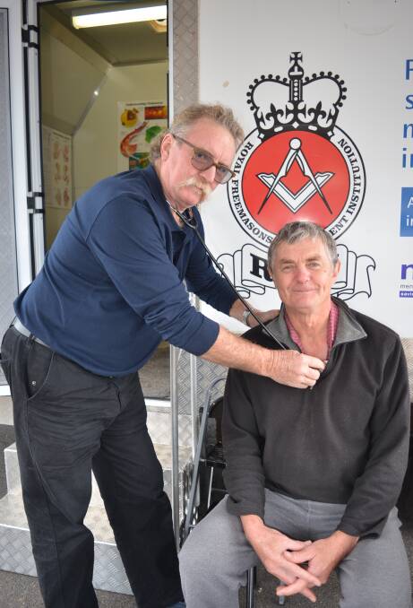 Registered nurse Rob Woolley checks the health of local Graham Dickson at the men's health van. The van is visiting 29 towns in 14 weeks. Photo: MARK RAYNER