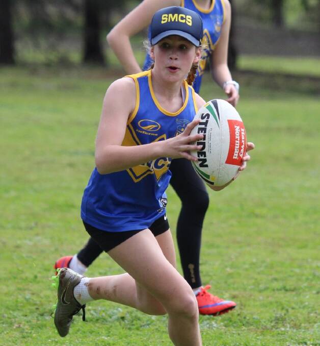 On the burst: Josie Clarke runs the ball in the Quinn Cup match. St Mary's went on to record its fifth straight win in the touch football. Photo contributed. 