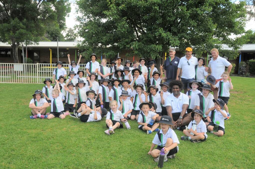 Developing: The schoolkids alongside the former Wallaby greats. Photo: Contributed.