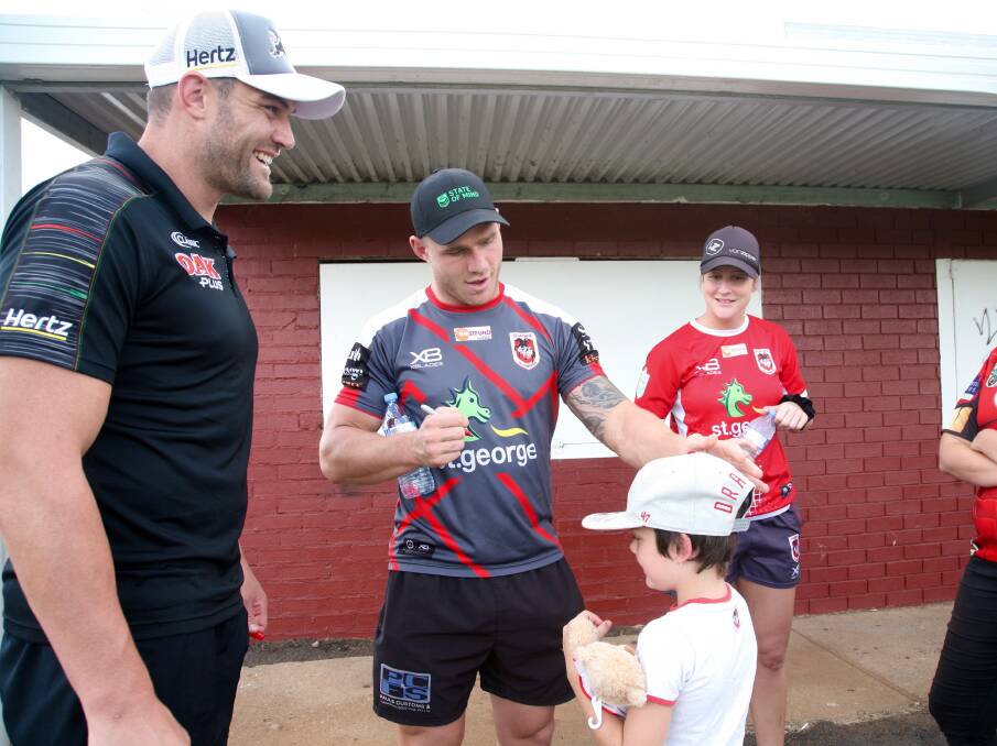 Starstruck: Tim Grant, Euan Aitken and Talesha Quinn sign a young fan's hat. Photo: Jo Ivey. 
