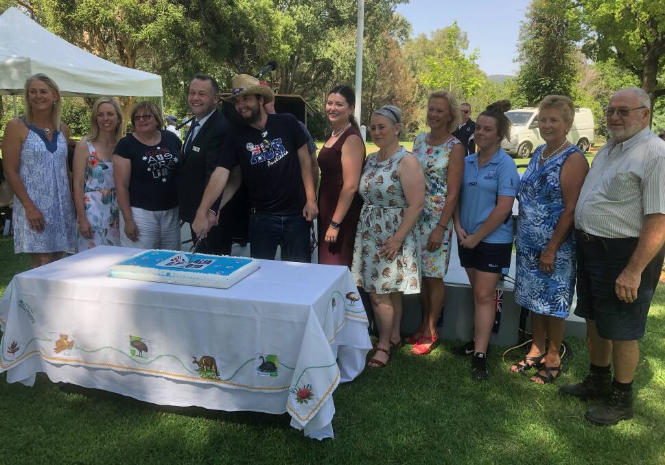 The award winners and Mayor Ben Shields cut the celebratory Australia Day cake alongside Ambassador 