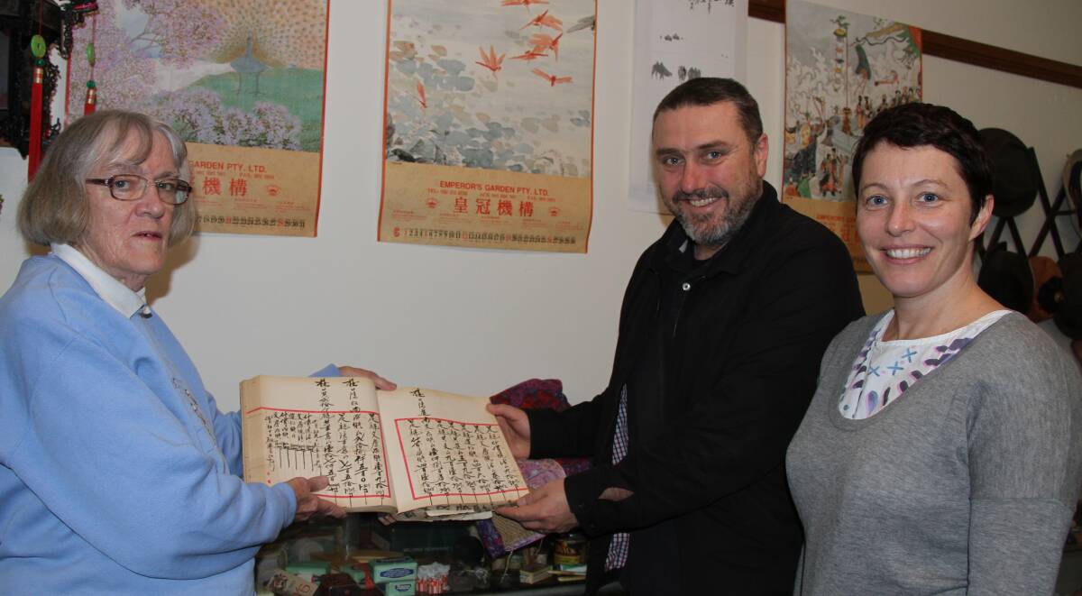 Wellington from the outside in: Oxley Museum curator Dorothy Blake shows Sydney art curators Glenn Barkley and Holly Williams some intriguing exhibits of Wellington's Chinese history.