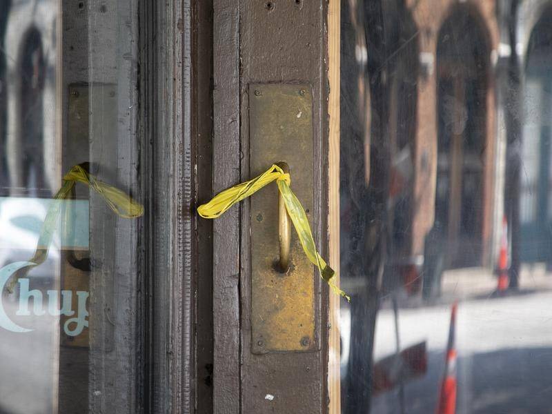 Caution tape remains on a door after an early morning mass shooting in downtown Austin, Texas.