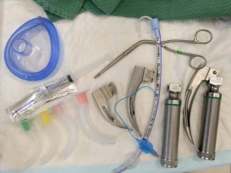 An anaesthetist who examined a patient's rectum without consent says he did so reluctantly.
