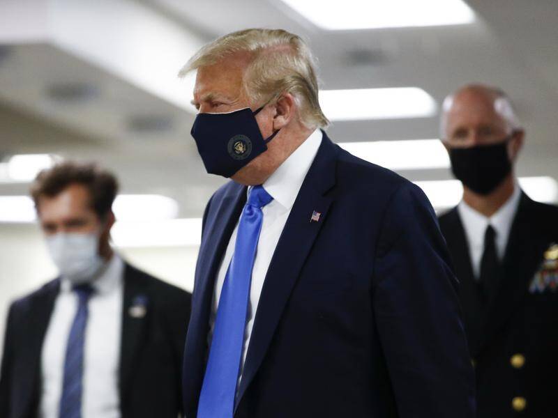 Donald Trump has worn a mask as he visited the Walter Reed Military Medical Center in Maryland.
