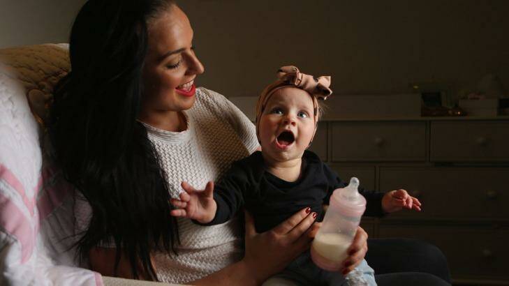 Tara Lloyd feeds her eight-month-old daughter Gracie Perkin a2 Platinum infant formula. Photo: Wayne Taylor