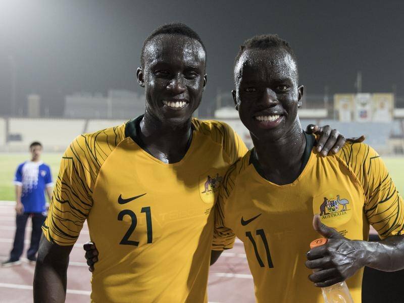 Thomas Deng (left), the most recent Olyroos captain, with Awer Mabil.
