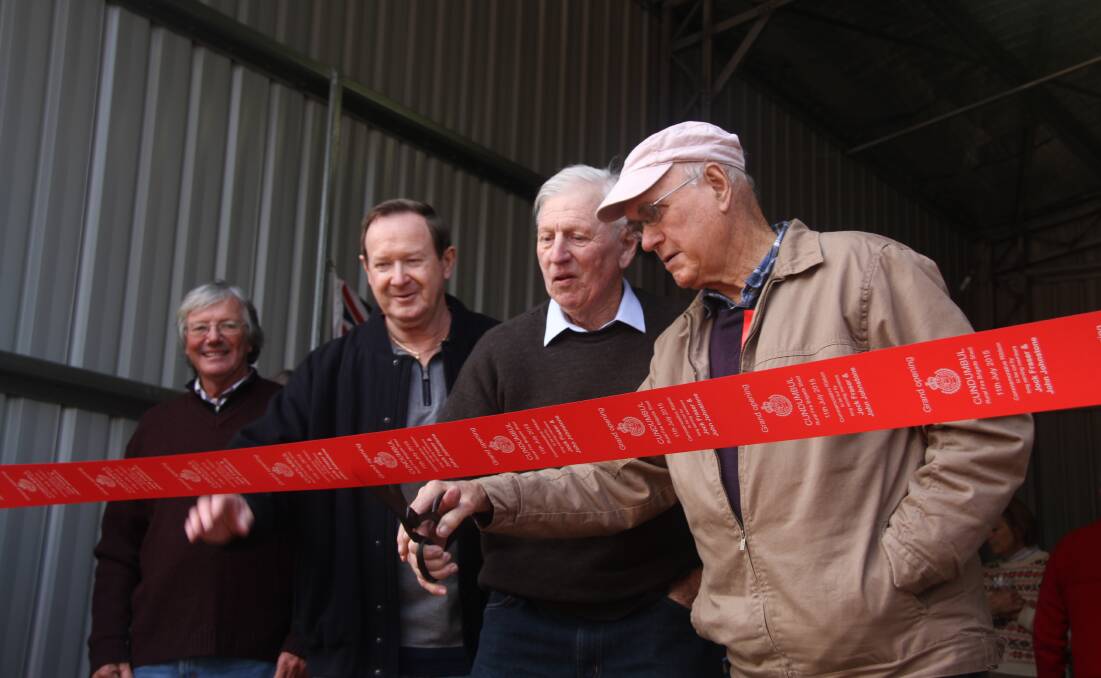 Captain Peter Hickey, council representative Bryson Rees, Jock Fraser and John Johnstone cut the ribbon at the new shed.