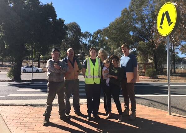 HIGHWAY PLAN: Adam Cleary, Carl Giffin, Glenn Irwin, Trish Farley, Charlie Newberry, Violet Seibert and Chris Newberry want the pedestrian crossing to remain. Photo: CONTRIBUTED