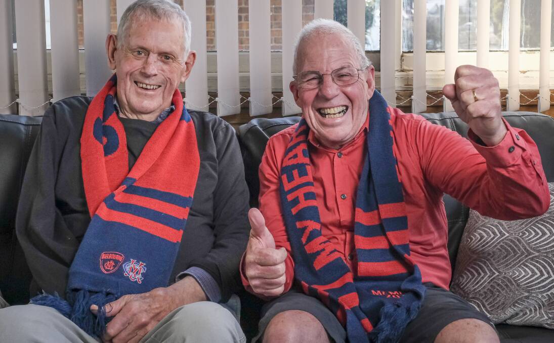 Lifelong Melbourne Demons fans Stan Plummer, 88, and Malcolm Cowan, 63. Photo: Craig George
