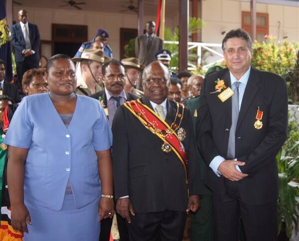 Mitchell Cornish (far right) at his investiture with  Papua New Guinea governor general Sir Micheal Ogio (centre) and Lady Ogio.