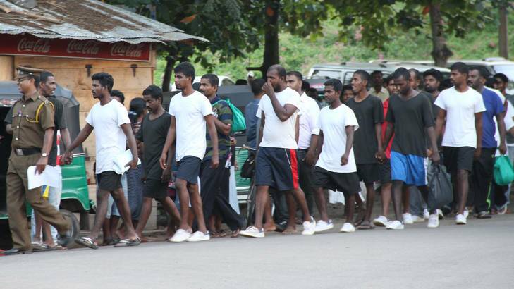 The latest batch of Sri Lankan deportees from Australia is led, through the streets of Negombo.