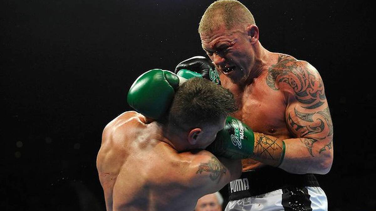 Shane Cameron lands some strong punches on Danny Green. Photo: Justin McManus